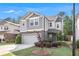 Charming two-story home with a two-car garage and gray siding, complemented by manicured landscaping at 2769 Morgan Spring Trl, Buford, GA 30519
