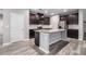 Modern kitchen with dark cabinetry, granite countertops, stainless steel appliances, and a large kitchen island at 2769 Morgan Spring Trl, Buford, GA 30519