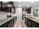 Spacious kitchen featuring granite counters, stainless steel appliances and plenty of dark wood cabinet space at 2769 Morgan Spring Trl, Buford, GA 30519