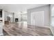 Bright, open-concept living room with modern gray flooring and a cozy fireplace at 2769 Morgan Spring Trl, Buford, GA 30519