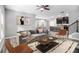 Open-concept living room with modern furnishings, adjacent to kitchen and dining area at 2769 Morgan Spring Trl, Buford, GA 30519
