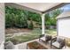 Inviting covered patio offers a serene outdoor space with lush landscaping, perfect for relaxation and entertaining at 2769 Morgan Spring Trl, Buford, GA 30519
