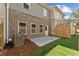Backyard view of brick and gray siding and a concrete patio at 4663 Larkfield Way, Powder Springs, GA 30127