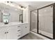 Modern bathroom with a double vanity, sleek black fixtures, and glass shower door at 4663 Larkfield Way, Powder Springs, GA 30127