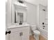 Bright bathroom with vanity sink, tub and toilet, all in neutral colors at 4663 Larkfield Way, Powder Springs, GA 30127