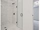 Sleek bathroom featuring a marble-tiled shower, glass door, and modern fixtures at 4663 Larkfield Way, Powder Springs, GA 30127