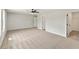 Large bedroom with neutral colored carpet, base trim and two interior doors at 4663 Larkfield Way, Powder Springs, GA 30127