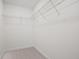 Walk-in closet with white shelving and ample storage space at 4663 Larkfield Way, Powder Springs, GA 30127