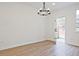 Bright dining area with wood floors, contemporary lighting, and access to the backyard through a glass door at 4663 Larkfield Way, Powder Springs, GA 30127