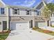 Inviting townhome showcasing brick and siding facade, individual driveways, and well-manicured landscaping at 4663 Larkfield Way, Powder Springs, GA 30127