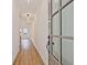 Bright hallway with light-colored wood floors and a view to a kitchen area at 4663 Larkfield Way, Powder Springs, GA 30127