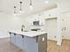 Bright kitchen showcasing pendant lighting over a gray island with white countertops at 4663 Larkfield Way, Powder Springs, GA 30127
