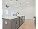 Modern kitchen area with stainless steel appliances and a kitchen island at 4663 Larkfield Way, Powder Springs, GA 30127