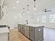 Open-concept kitchen featuring an island with seating and stainless steel appliances at 4663 Larkfield Way, Powder Springs, GA 30127