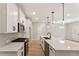 Modern kitchen with white cabinets, stone countertops, and stainless steel appliances at 4663 Larkfield Way, Powder Springs, GA 30127