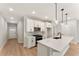 Modern kitchen features a central island, stainless steel appliances, and stylish pendant lighting at 4663 Larkfield Way, Powder Springs, GA 30127