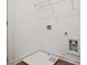 Modern laundry room with hookups, white walls, and hardwood floors at 4663 Larkfield Way, Powder Springs, GA 30127