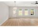 Spacious living room with hardwood floors and multiple windows offering natural light at 4663 Larkfield Way, Powder Springs, GA 30127