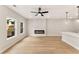 Inviting living room with modern fireplace and large windows offering an abundance of natural light at 4663 Larkfield Way, Powder Springs, GA 30127