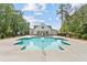 Community pool with bright blue water, a pool house, and mature trees create a serene and inviting outdoor space at 4663 Larkfield Way, Powder Springs, GA 30127