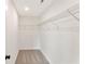 Walk-in closet featuring neutral carpet, metal storage shelving and overhead lighting at 4663 Larkfield Way, Powder Springs, GA 30127