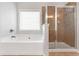 Bright bathroom featuring a separate shower and soaking tub, providing options for relaxation and convenience at 5645 Carrington Pl, Cumming, GA 30040