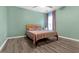Comfortable bedroom provides natural light and hardwood floors at 5645 Carrington Pl, Cumming, GA 30040