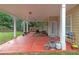 Spacious covered patio with a seating area, grill, and plant accents, perfect for enjoying the outdoors at 5645 Carrington Pl, Cumming, GA 30040