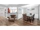 Open-concept dining area with hardwood floors, elegant table setting, and stylish decor at 5645 Carrington Pl, Cumming, GA 30040