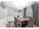 Formal dining room with hardwood floors, elegant chandelier, and stylish decor at 5645 Carrington Pl, Cumming, GA 30040
