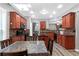 Open kitchen boasts wood cabinets, granite countertops, and stainless steel appliances at 5645 Carrington Pl, Cumming, GA 30040