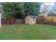 Backyard featuring a storage shed, providing ample space for organizing outdoor equipment at 5645 Carrington Pl, Cumming, GA 30040