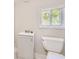 Bathroom featuring a modern toilet and vanity with newly tiled floors at 971 Sims Nw Ave, Atlanta, GA 30318