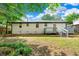 A long, low view shows the back of the white brick home and its backyard at 2125 Lynn Sw Dr, Marietta, GA 30060