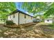 A long, low view shows the full backyard and exterior of the white brick home at 2125 Lynn Sw Dr, Marietta, GA 30060
