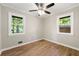 Bright bedroom features hardwood floors, two windows for natural light, and neutral walls, creating a calm space at 2125 Lynn Sw Dr, Marietta, GA 30060