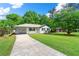 A charming white brick home with a manicured lawn and driveway on a sunny day at 2125 Lynn Sw Dr, Marietta, GA 30060