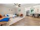 Bright living room features a modern ceiling fan and an adjacent dining area with stainless steel appliances at 2125 Lynn Sw Dr, Marietta, GA 30060