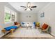 Light-filled living room boasts neutral walls, a ceiling fan, and an abundance of natural light from a large window at 2125 Lynn Sw Dr, Marietta, GA 30060
