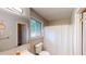 Bright bathroom features white shower with a shower curtain, new toilet and vanity at 271 Leafwood Ln, Riverdale, GA 30274