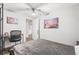 Comfortable bedroom with ceiling fan, artwork, desk area, and view to door number 8 at 271 Leafwood Ln, Riverdale, GA 30274