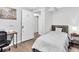 Bedroom with a bed, side table, desk with rolling chair, and dark-stained wood-look flooring at 271 Leafwood Ln, Riverdale, GA 30274