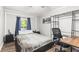 Bedroom featuring a bed, side tables, desk with rolling chair, and storage shelves at 271 Leafwood Ln, Riverdale, GA 30274