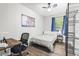 Bedroom with a bed, desk with rolling chair, and storage with dark-stained wood-look flooring at 271 Leafwood Ln, Riverdale, GA 30274