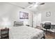 Bedroom with a bed, side tables, desk with rolling chair, and dark-stained wood-look flooring at 271 Leafwood Ln, Riverdale, GA 30274