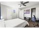 Neutral toned bedroom featuring a ceiling fan, closet, modern art and wood-look floors at 271 Leafwood Ln, Riverdale, GA 30274