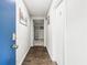 Hallway showcases wood-look flooring and is freshly painted. It leads to living spaces with new carpeting at 271 Leafwood Ln, Riverdale, GA 30274