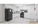 Kitchen featuring modern black appliances, granite counters and white cabinets at 271 Leafwood Ln, Riverdale, GA 30274