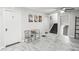 Living area with tile flooring, ceiling fan, table and chairs, and doors leading to other rooms at 271 Leafwood Ln, Riverdale, GA 30274
