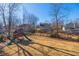The large backyard features a playground and views of other homes and trees at 1018 Jubilee Way, Powder Springs, GA 30127